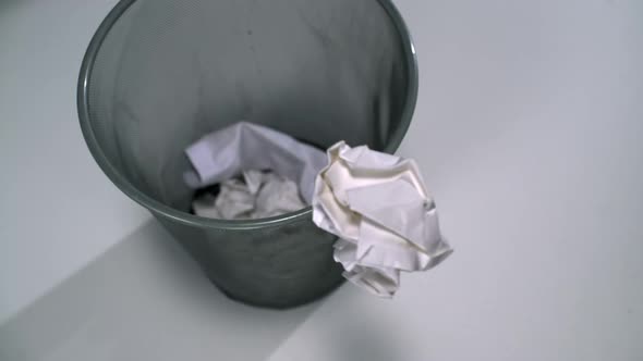 Tossing crushed paper into garbage can, Slow Motion