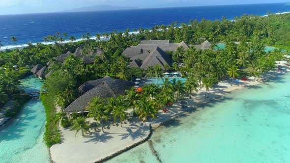 Aerial drone view of a luxury resort and pool in Bora Bora tropical island