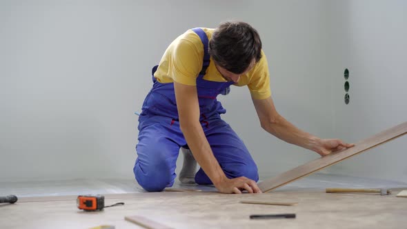 A Man Professional Laminate Installer Laying Laminate Wood