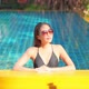 Young asian woman enjoy around outdoor swimming pool for leisure - VideoHive Item for Sale