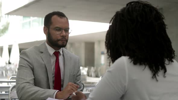 Focused Bearded Man Listening Colleague and Shaking Hands