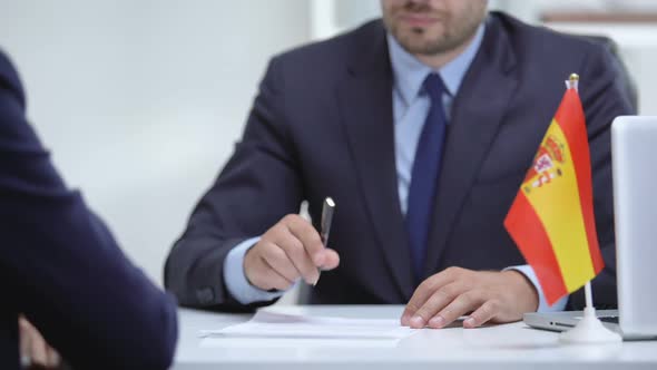 Spanish Boss Signing Employment Contract With Immigrant Employee, Shaking Hand