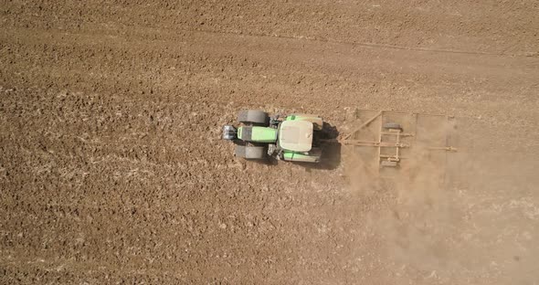 Aerial view of a tractor ploughing an empty field, Kibbutz saar, Israel.