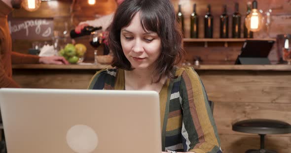 Pretty Young Female Blogger Working in a Cafe Environment