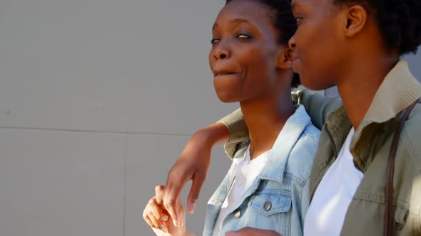 Twin sisters walking in the city 4k