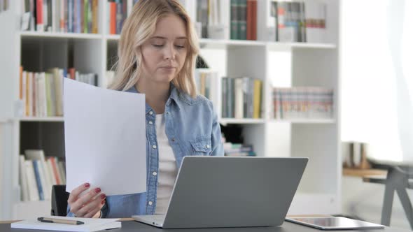 Young Woman Working on Documents and Laptop, Paperwork