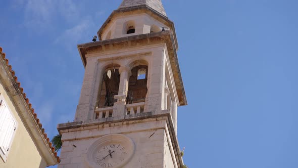 A Church with a Tall Bell Tower in the Old Town of Budva