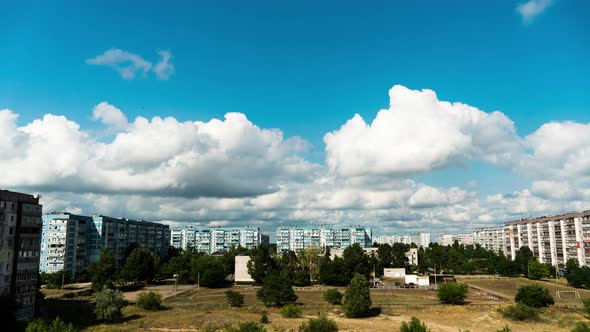 White Fluffy Clouds Slowly Float Through the Blue Daytime Sky Timelapse