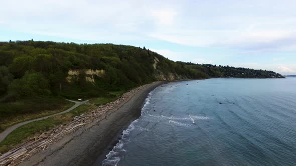 Wide aerial showing the wide coastline of Discovery Park in Seattle, Washingon.