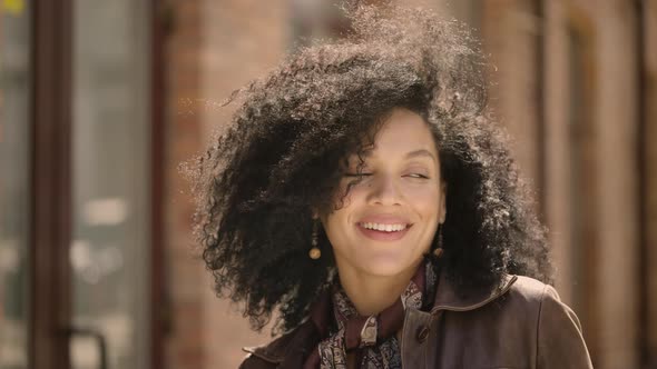 Portrait of Stylish Young African American Woman Flirtatious Smiling and Winking