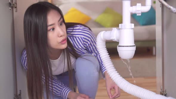 Surprised Young Asian Woman Saw a Leak Under the Sink Slow Mo
