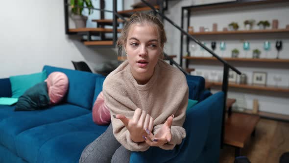 Selfie Camera POV of Confident Teenage Blogger Talking Looking at Camera Sitting on Couch in Living