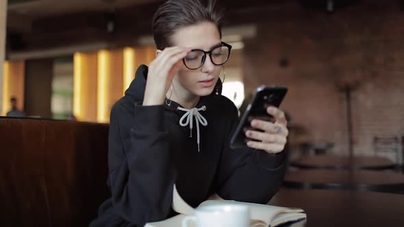 Excited Young Girl Surprised By News on Smartphone