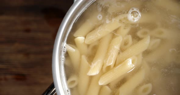 Penne Pasta Is Boiled in Boiling Water with Air Bubbles. 