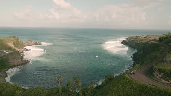 aerial floating out to sea over Honokohau Bay, Maui, Hawaii.  Long, flowing waves seem to drift in f