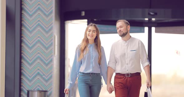 Beautiful Young Couple Entering the Mall