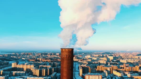 Aerial View of a Smoking Pipe of a Thermal Power Plant at Sunset