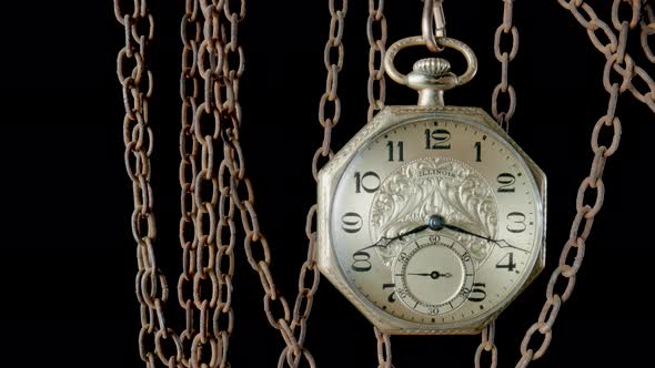 Antique Gold Pocket Watch Hanging From a Rough Rusty Chain