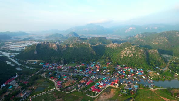 Aerial drone video of beautiful fishing seaside village. beautiful sea area in Thailand.