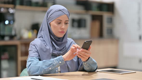 Attractive Arab Woman Using Smartphone at Work 
