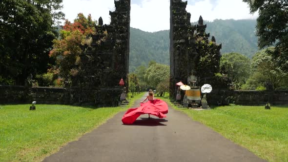 Woman Runs to Balinese Gates in Dress Slowmotion