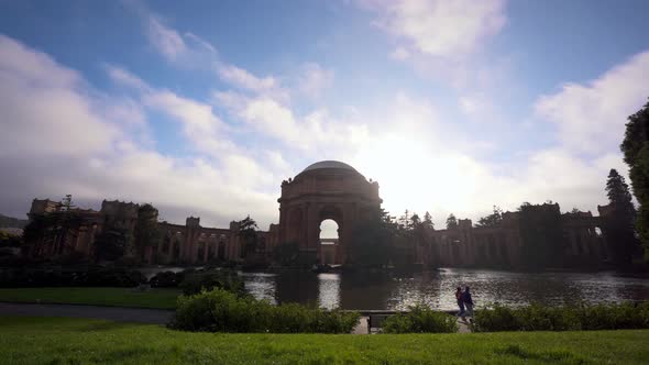 The Palace of Fine Arts, cloudsing fast and people walking by the lake