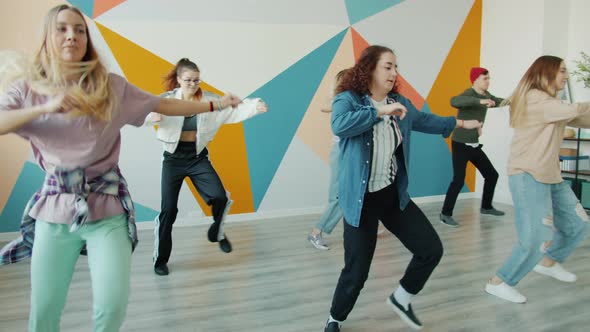 Joyful Students Dancing in Modern Hip-hop Studio Having Fun Together Indoors
