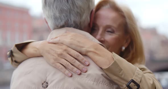 Close Up of Loving Attractive Middleaged Couple Embracing Outdoors