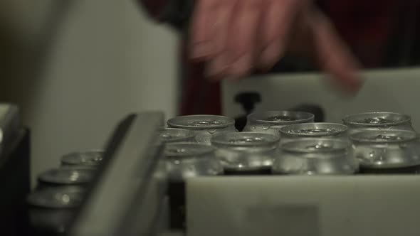 Microbrewery Worker Picks Up Freshly Canned Beer