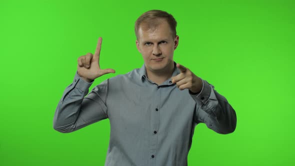 Guy Showing Loser Gesture, Pointing Finger To Camera, Sarcastic Smile, Blaming for Failure, Lost Job