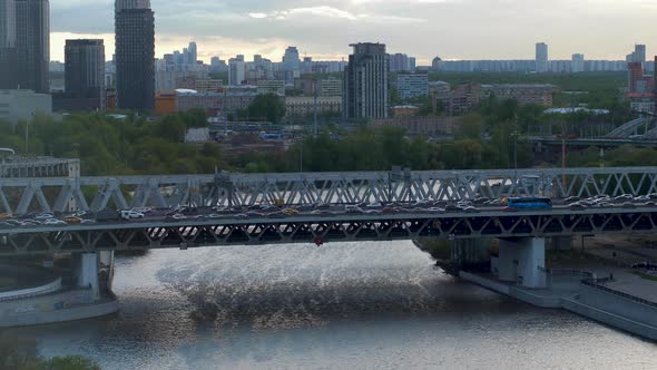 Long Bridge with Cars at Night in Moscow with a Busy Traffic Above the River