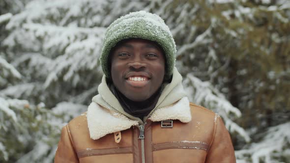 Portrait of Joyful African American Man in Winter Forest