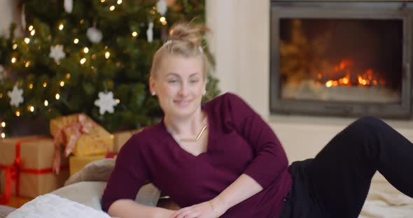 Smiling Young Woman Relaxing In Living Room