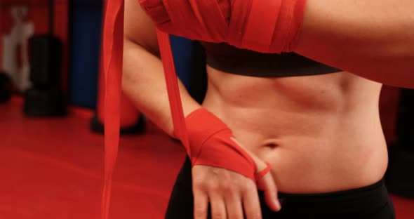 Female boxer wearing red strap on wrist