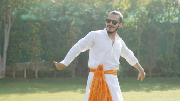 Cool Indian man dancing in an Indian traditional outfit Kurta Pajama