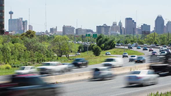 Busy freeway timelapse with cityscape background of San Antonio, Texas.