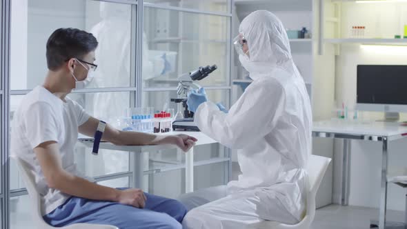 Doctor Taking Blood Sample from Infected Patient