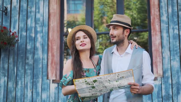 Couple of Tourists Are Exploring the Map in Travel. a Young Woman and a Man Walk Around the City on