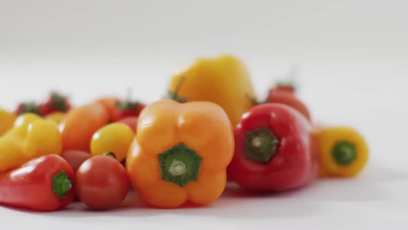 Video of fresh peppers and tomatoes with copy space on white background