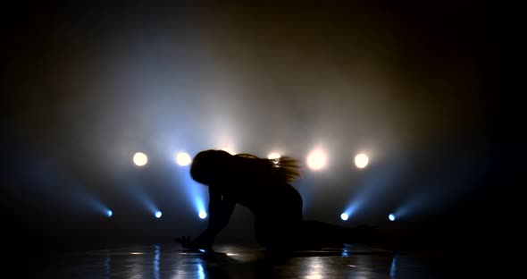 Silhouette of a Girl Dancing Erotically on the Floor