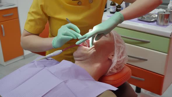 Person Undergoes a Medical Examination and Treatment of the Oral Cavity at the Dentist