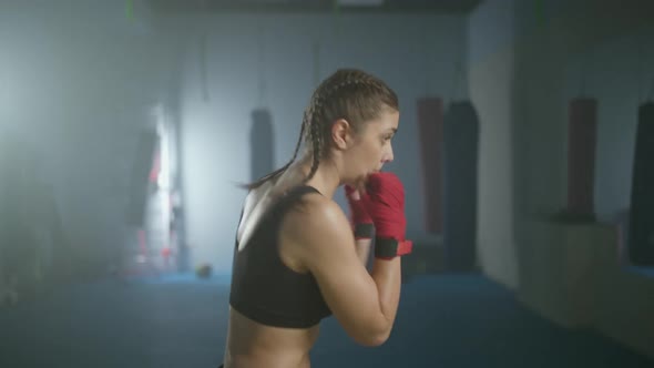 Caucasian Female Fighter Trains His Punches and Defense in the Boxing Gym a Boxer Trains in Front of