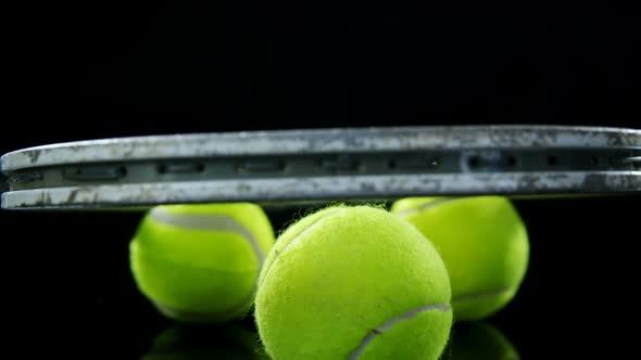 Tennis balls and racket in studio 4k