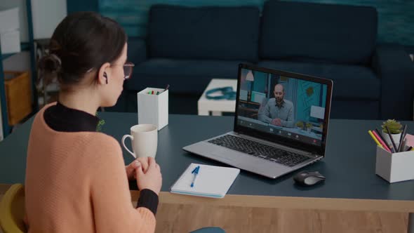 Young Woman Meeting with Teacher on Remote Video Call alt