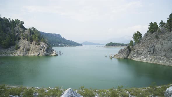 Aerial Lake View Between Mountains and Trees 4K