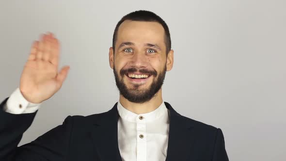 Young Beautiful Businessman in Blue Suit Smiling and Waving Her Hand Greeting Customers