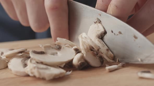 Men Chef Cut Mushrooms with Knife for Salad in the Kitchen and Man Home Cooking