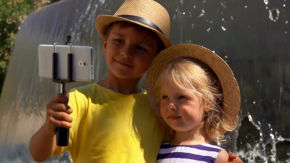 Boy and a Girl Take a Selfie Photo at the Fountain