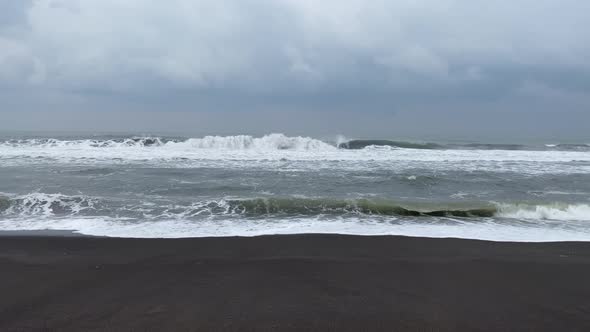 Waves Crashing on Beach in Yogyakarta, Indonesia - Static Shot on Overcast Day