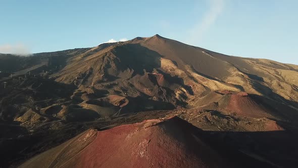 Drone flight over a large crater of the Etna volcano, Sicily, Italy.